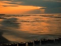 Baltic Sea with breakwaters at sunset Royalty Free Stock Photo