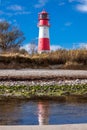 Baltic sea dunes lighthouse in red and white