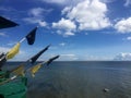 Fishing boat flag poles with blue sea and sky