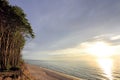 Baltic Sea shore wooded cliff and beach during colorful sunset Royalty Free Stock Photo