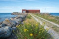 Baltic Sea with stones and rustic building .