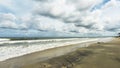 The Baltic Sea in summer, stones washed ashore, clouds over the sea, waves come to the sandy beach. selective focus Royalty Free Stock Photo