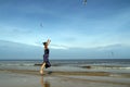 Baltic sea, woman in summer dress jumping and feeding white g Royalty Free Stock Photo