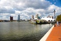 Baltimore Canal East Harbor. Embankment with modern high-rise buildings and historic buildings. Clouds and blue sky over the city Royalty Free Stock Photo