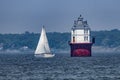 The Baltimore Harbor Light Lighthouse in the Chesapeake Bay with a sailboat