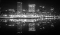 Baltimore skyline and docks reflecting in the water at night Royalty Free Stock Photo