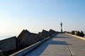 Kaliningrad region, Southern pier on the Baltic spit, concrete breakwaters, lighthouse in the Baltic Sea Royalty Free Stock Photo