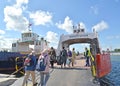 BALTIYSK, RUSSIA. People climb the passenger-automobile self-propelled ferry Vistula. Russian text