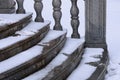 Balustrade of the rotunda under the snow. Gray granite exterior details during a snowfall. Fragment of a city landmark