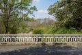 Balustraded road bridge in verdant city at sunny spring noon Royalty Free Stock Photo