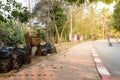 Bamboo basket and black bag use for keep garbage near walkpath in garden