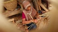 Bamboo basket craftswoman while doing his work Royalty Free Stock Photo