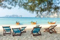 Bamboo beach chairs and traditional long-tail boats