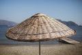 Bamboo beach umbrella on the background of the sea, beach. Royalty Free Stock Photo