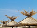 Bamboo beach umbrellas concept over blue sky Royalty Free Stock Photo