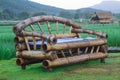 Bamboo bench on the lawn surrounded by fields.