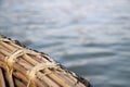 A bamboo boat tied tightly with string over the river in India of Asia