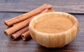 Bamboo bowl with cinnamon powder and sticks Royalty Free Stock Photo