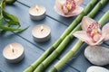 Bamboo branches, orchids and candles Royalty Free Stock Photo