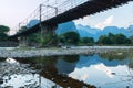 Bamboo bridge over Nam Song River at Vang Vieng village Royalty Free Stock Photo