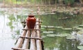 Bamboo bridge on the pond with water lily flowers Royalty Free Stock Photo