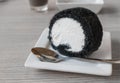 Bamboo charcoal roll cake on white plate