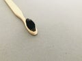 Charcoal infused bamboo toothbrush on grey texture background. Copy space.