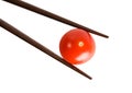Bamboo chopsticks and cherry tomato Royalty Free Stock Photo