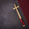 Bamboo chopsticks and red black mat. Asian Japanese table setting Royalty Free Stock Photo