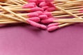 Bamboo cotton swabs buds sticks on a purple background, close-up