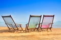 Bamboo deck chairs on the sandy beach with bright sun and waves, Island south of THAILAND. Relaxing day at the beach Royalty Free Stock Photo