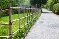 Bamboo fence is along ground road in countryside of small Japanese village. Japan Royalty Free Stock Photo