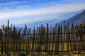 Bamboo fence in rural field with beautiful natural mountain land