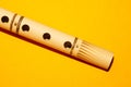 Bamboo flute. simple wind instrument on yellow background