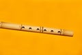 Bamboo flute. simple wind instrument on yellow background