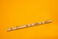 Bamboo flute. simple wind instrument on yellow background