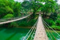 Bamboo hanging bridge over river Royalty Free Stock Photo