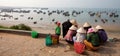 Bamboo hat Vietnamese women choose fish to sell in market