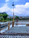 Bamboo lamp post and train under blue sky with rustic bamboo fence and floor Royalty Free Stock Photo