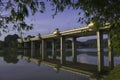 Bamboo leaves framing lake bridge Royalty Free Stock Photo