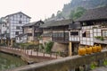 Bamboo lidded baskets on stone balustrade of bridge in ancient town Royalty Free Stock Photo