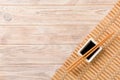 Bamboo mat and soy sauce with sushi chopsticks on wooden table. Top view with copy space background for sushi. Flat lay Royalty Free Stock Photo