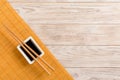 Bamboo mat and soy sauce with sushi chopsticks on wooden table. Top view with copy space background for sushi. Flat lay Royalty Free Stock Photo