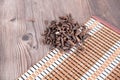 Bamboo mat on the table and a pile of traditional Chinese medicine xiangfuzi Royalty Free Stock Photo