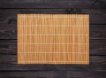 Bamboo mat on a wooden table, top view Royalty Free Stock Photo