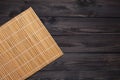 Bamboo mat on wooden table, top view Royalty Free Stock Photo