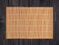 Bamboo mat on wooden table, top view Royalty Free Stock Photo