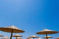 Bamboo parasols beach umbrellas with clear blue sky background on summer day