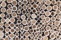 bamboo pile stacked vertically create texture wall background. Circle in front of pipes pattern Royalty Free Stock Photo