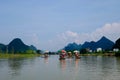 Bamboo rafts floating on wide LijiangLi river Royalty Free Stock Photo